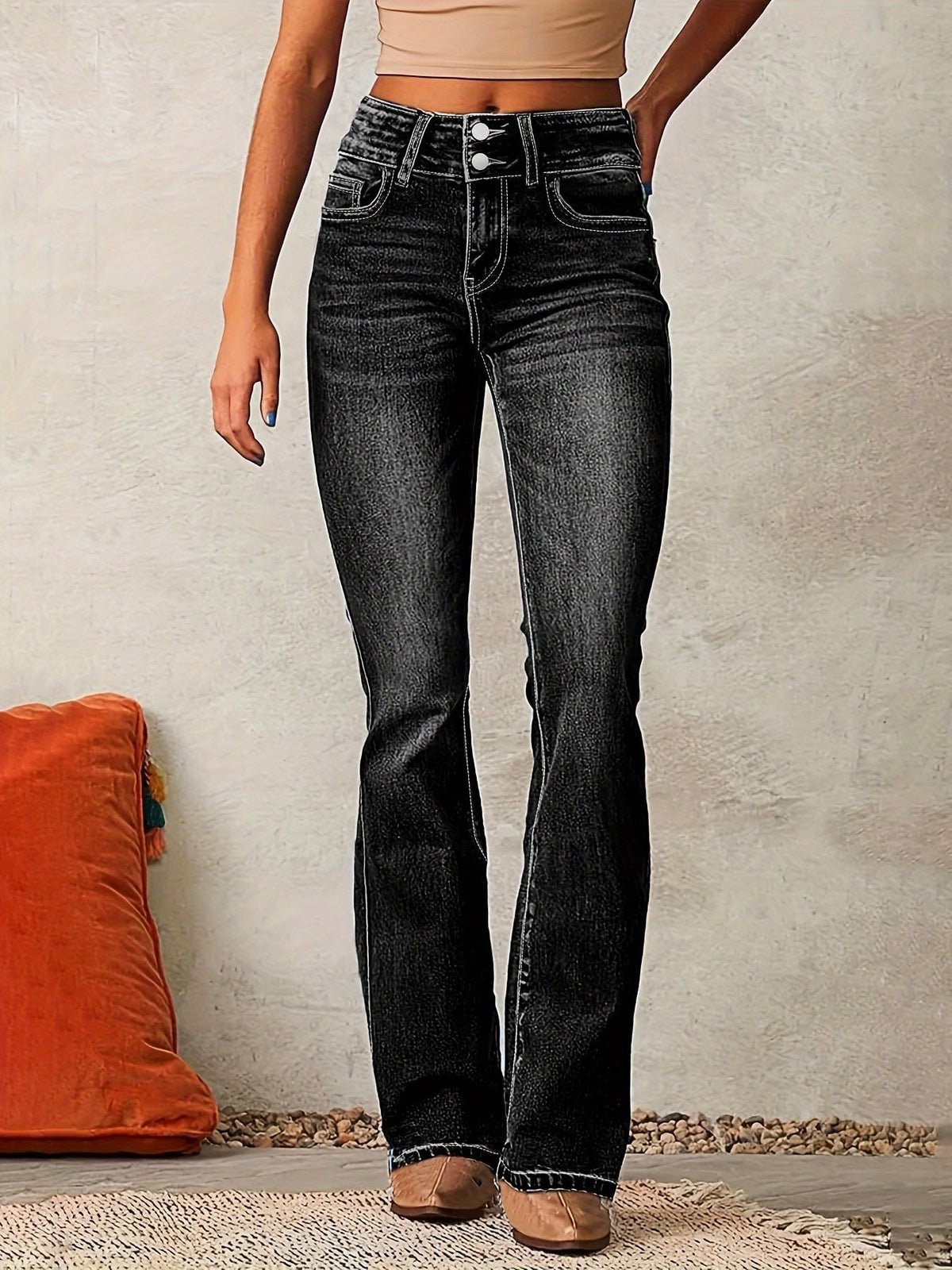 Front view of black high-waisted flared jeans with contrasting light stitching, a button and zip closure, and five-pocket styling.
