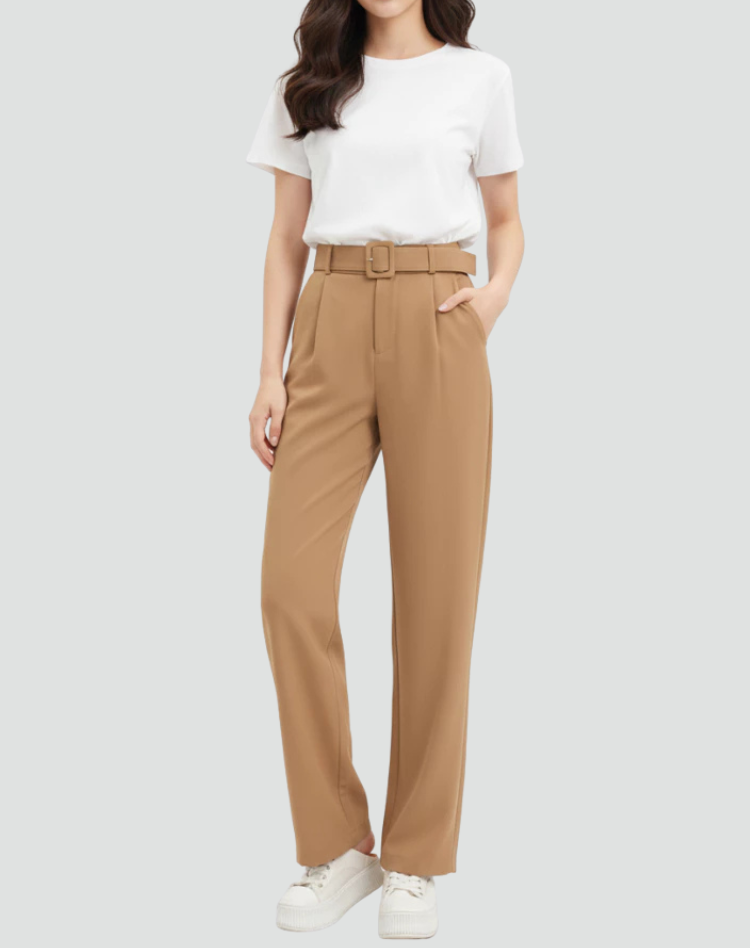 Camel-colored high-waisted pleated trousers with tapered ankle-length legs, styled with a white short-sleeved top and sneakers.