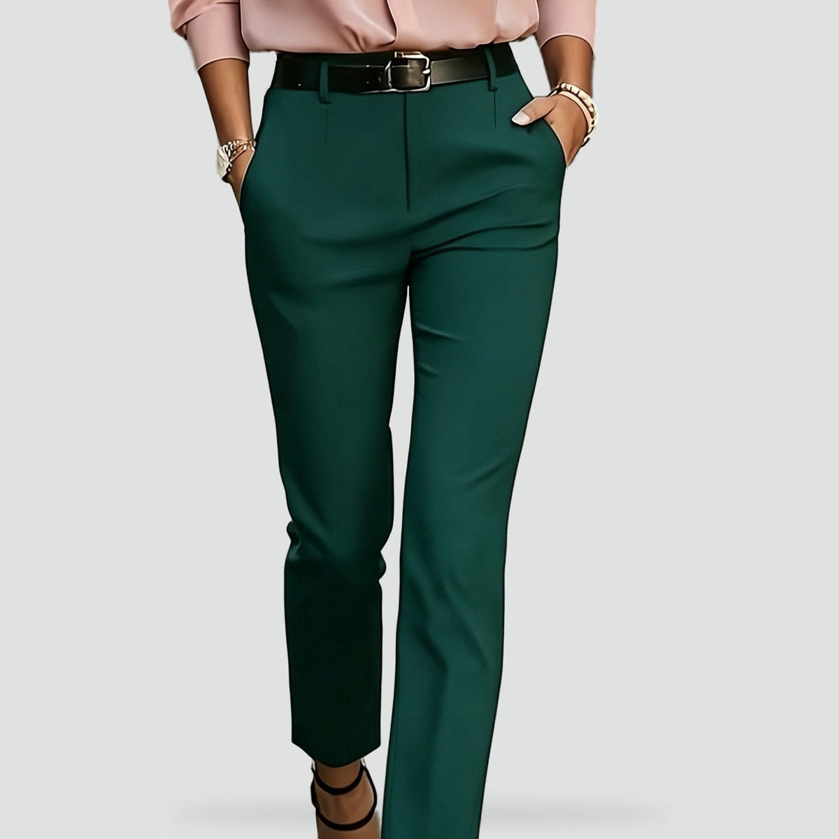 Green high-waisted ankle trousers shown from the waist to the lower legs, with both side pockets visible.