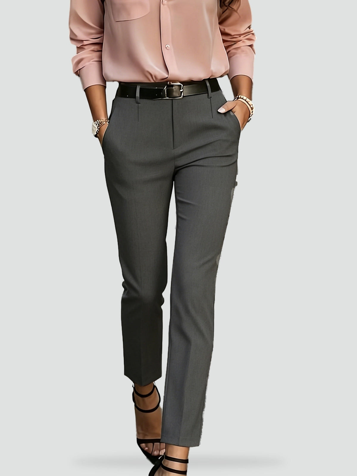 Gray high-waisted trousers featuring a streamlined ankle-length leg and angled side pockets.