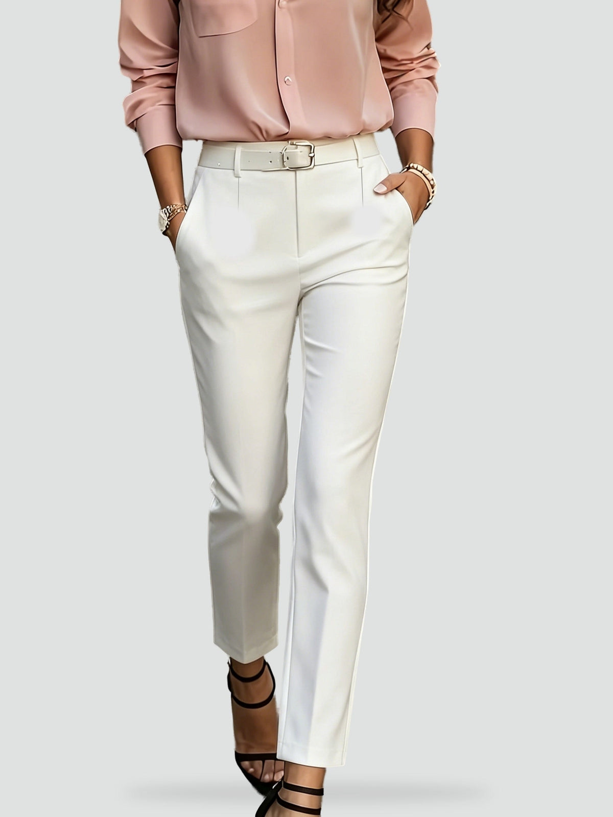 White slim-fit ankle trousers displayed with a defined waistband, front closure, and slanted pockets.