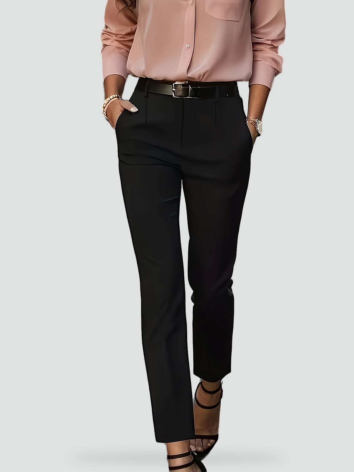 Black slim-fit ankle trousers shown in a full-length front view with hands placed in the side pockets.