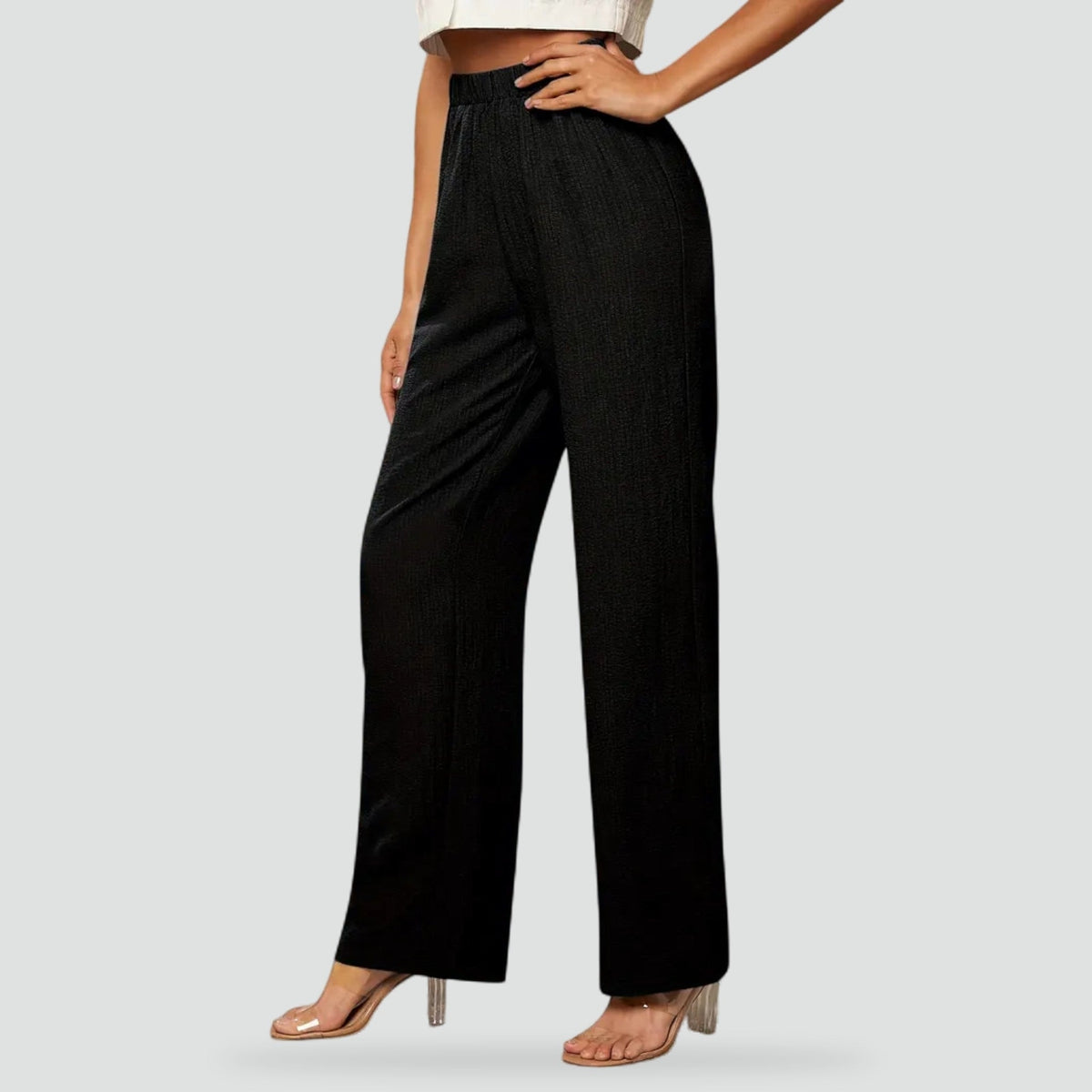 Black high-waisted straight-leg trousers shown from the front, with a relaxed fit through the legs and side pockets.