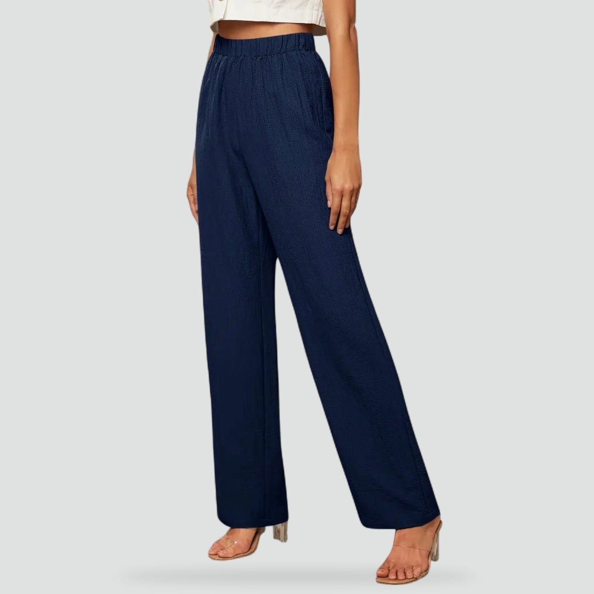 Navy high-waisted straight-leg trousers shown from the front with an elasticated waistband and full-length cut.