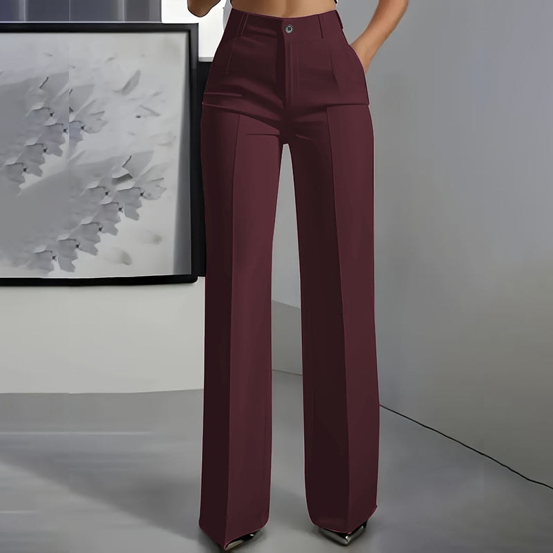 Front view of burgundy high-waisted wide-leg pants with long full-length legs and front pleats.