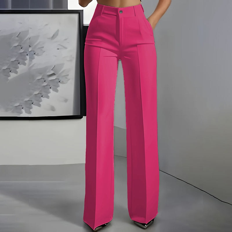 Front view of bright pink high-waisted wide-leg pants featuring a button closure, side pockets, and tailored pleats.