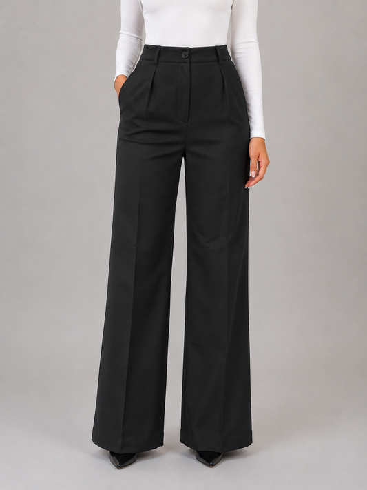 Front view of black high-waisted wide-leg tailored trousers with front pleats, button and zip closure, and side pockets.
