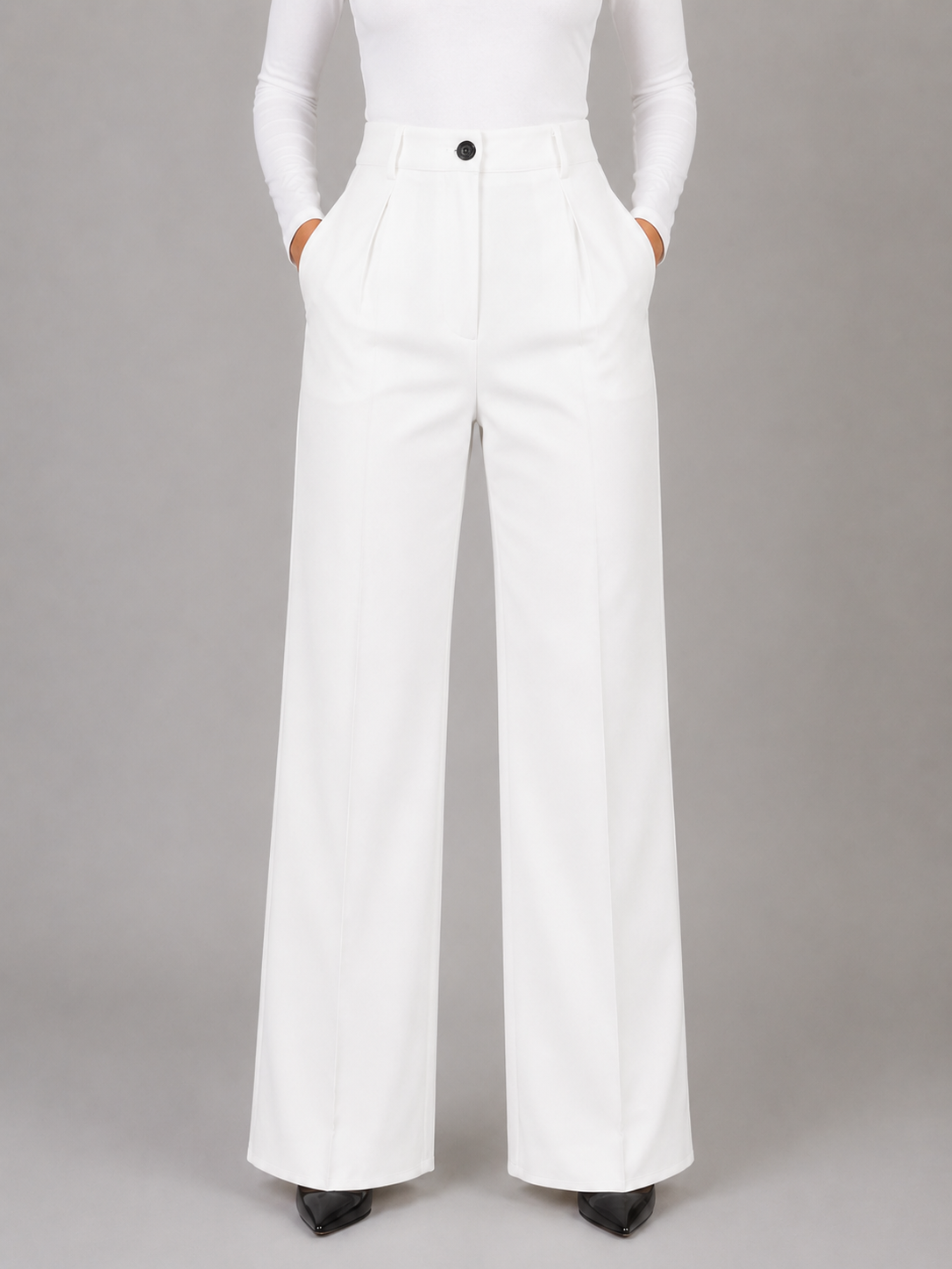 Front view of white high-waisted wide-leg trousers with a clean waistband, pleated front, and inset side pockets.