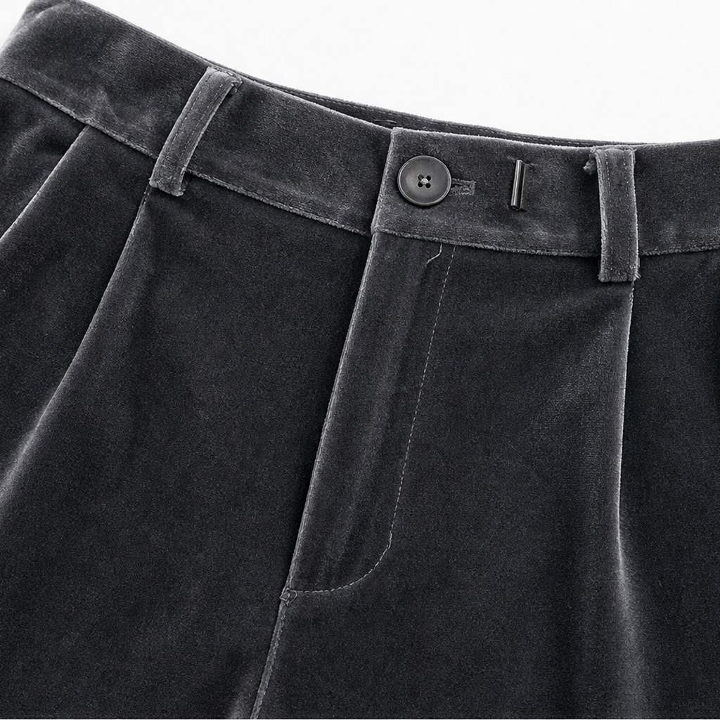Close-up of the high waistband showing belt loops, front button, zip closure, and a curved side pocket opening.