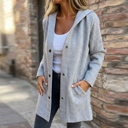 Gray hooded longline cardigan worn open over a white top, with long sleeves, front buttons, and two patch pockets.