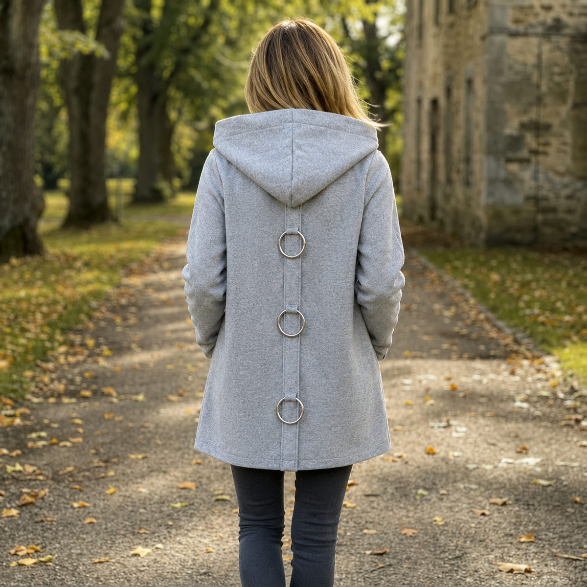 Back view of the gray longline cardigan showing the hood, center seam, and three circular back accents.