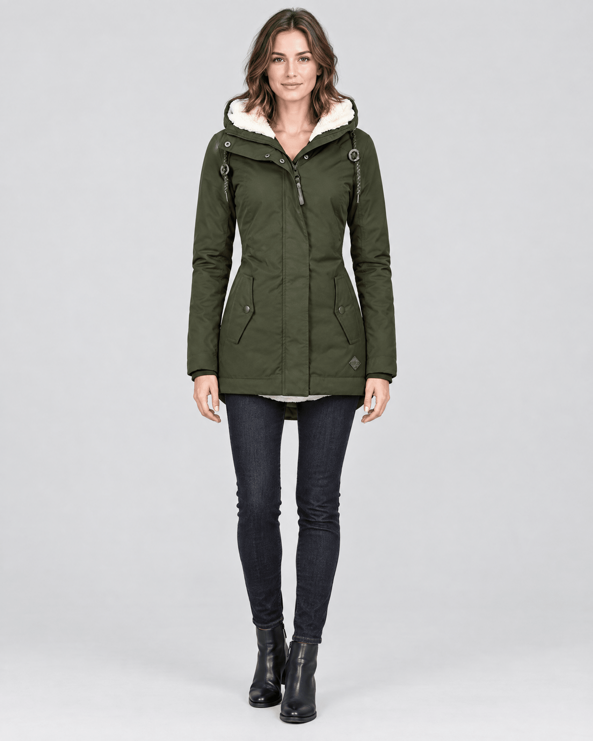 Front view of the olive green hooded jacket worn with the hood open, front zipper, and two angled pockets.