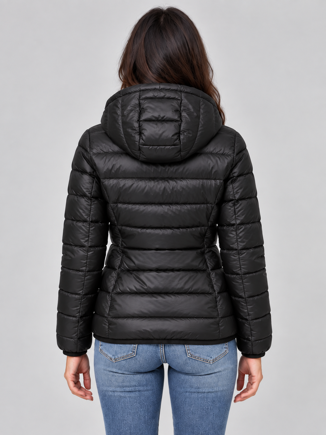 Back view of the black hooded puffer jacket showing the attached hood, horizontal quilting, long sleeves, and hip-length fit.