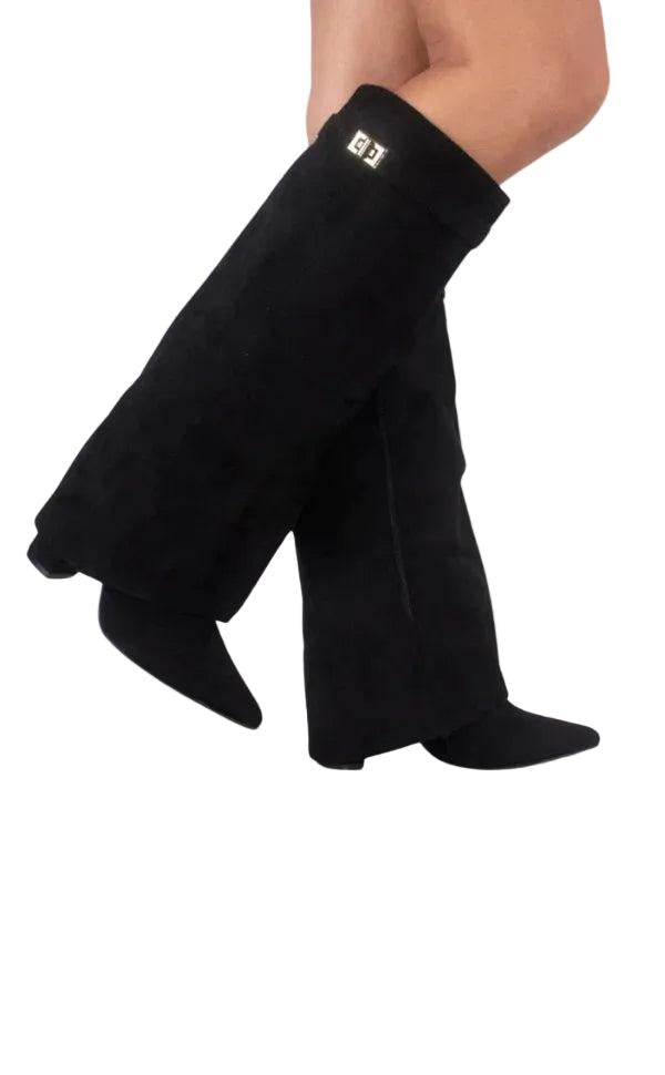 Black knee-high boots shown crossed, with pointed toes, block heels, and a small metal accent on the shaft.