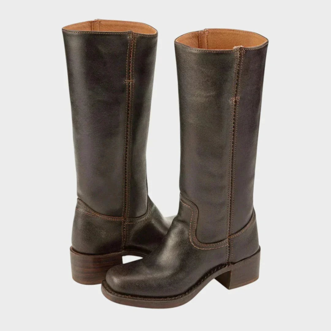 Dark brown knee-high boots displayed from the rear three-quarter angle, showing the tall shafts, pull-on design, and stacked block heels.