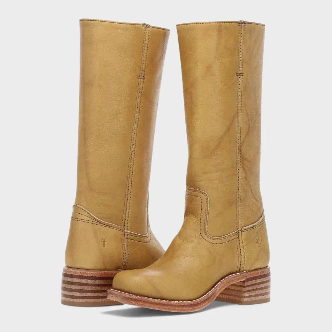 Golden tan knee-high boots shown facing forward, featuring streamlined shafts, rounded toes, and contrasting layered block heels.