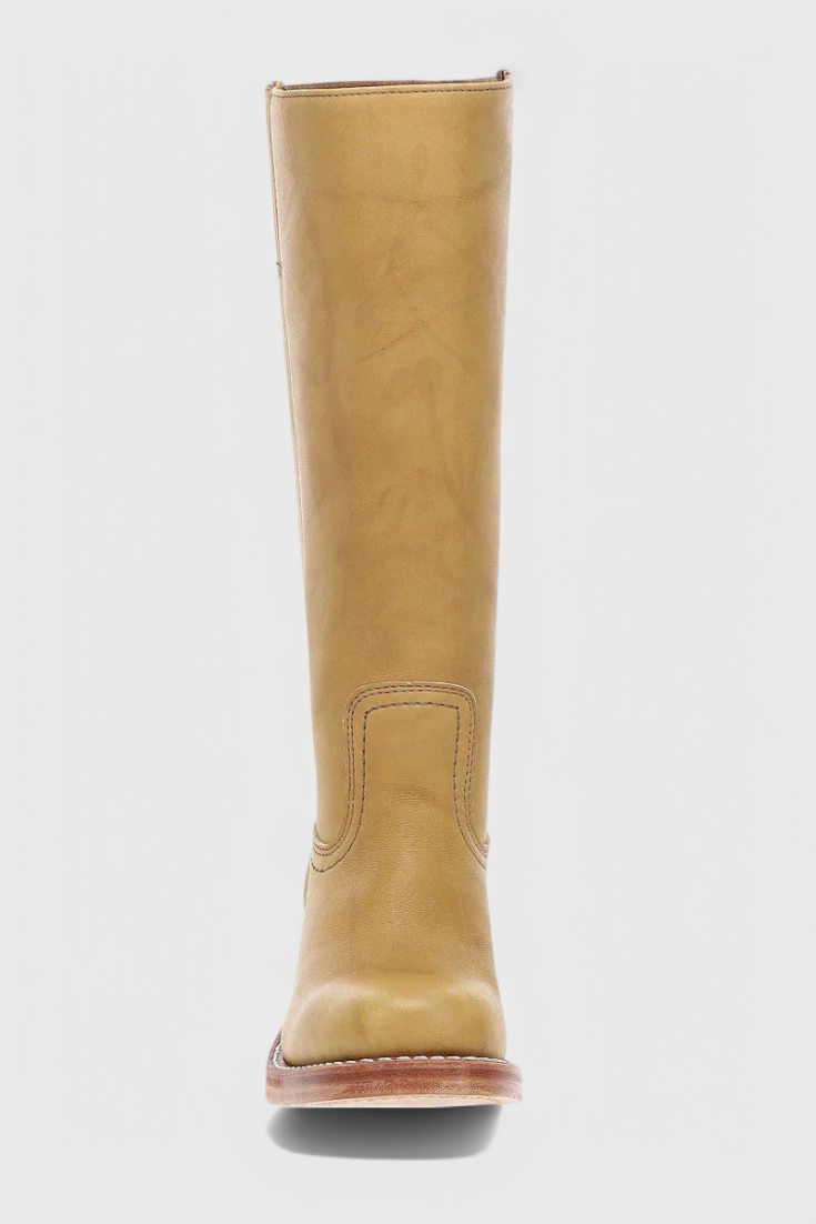 Tan knee-high boot shown from the front, displaying the rounded toe, tall shaft, and stitched ankle panel.