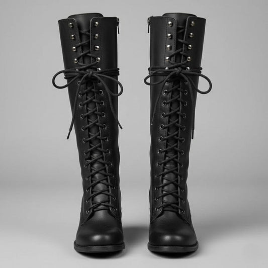 Pair of black knee-high lace-up boots shown from the front with round toes, metal eyelets, and block heels.