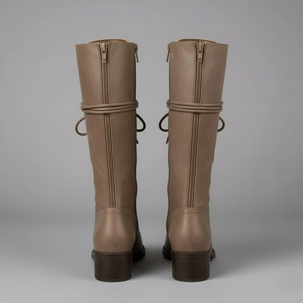 Back view of taupe knee-high boots showing their full-length rear zippers, rounded heel counters, and block heels.
