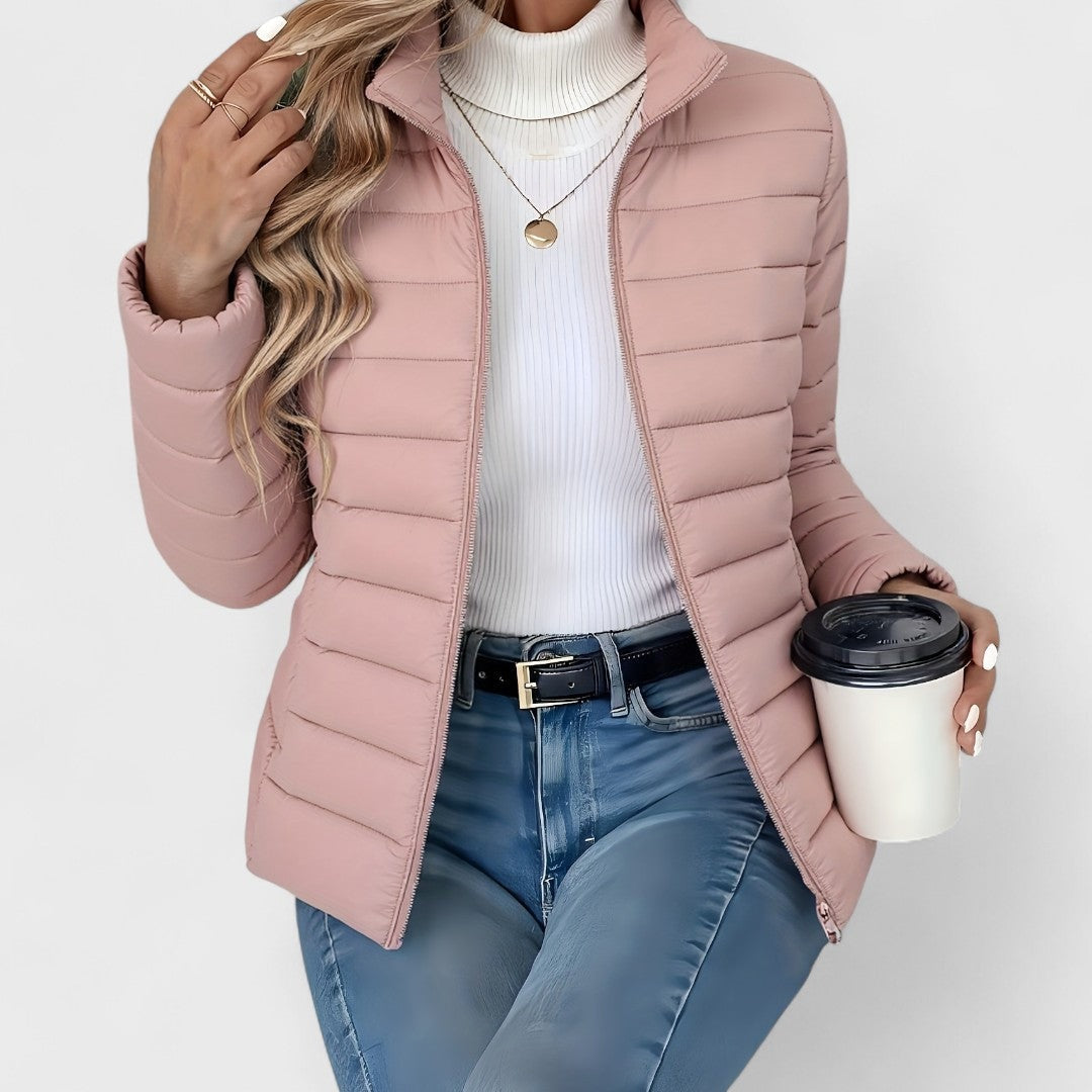 Dusty pink quilted jacket with an open front, stand collar, long sleeves, and hip-length cut.