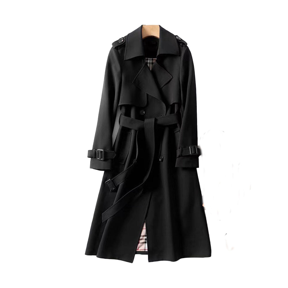 Black long double-breasted trench coat with a belted waist, wide collar, buckled cuff tabs, shoulder epaulettes, and a plaid-patterned lining visible at the opening.