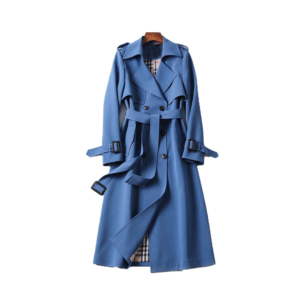 Blue long double-breasted trench coat with a draped tie belt, buckled cuff tabs, shoulder epaulettes, storm flap, and contrasting plaid-patterned lining.
