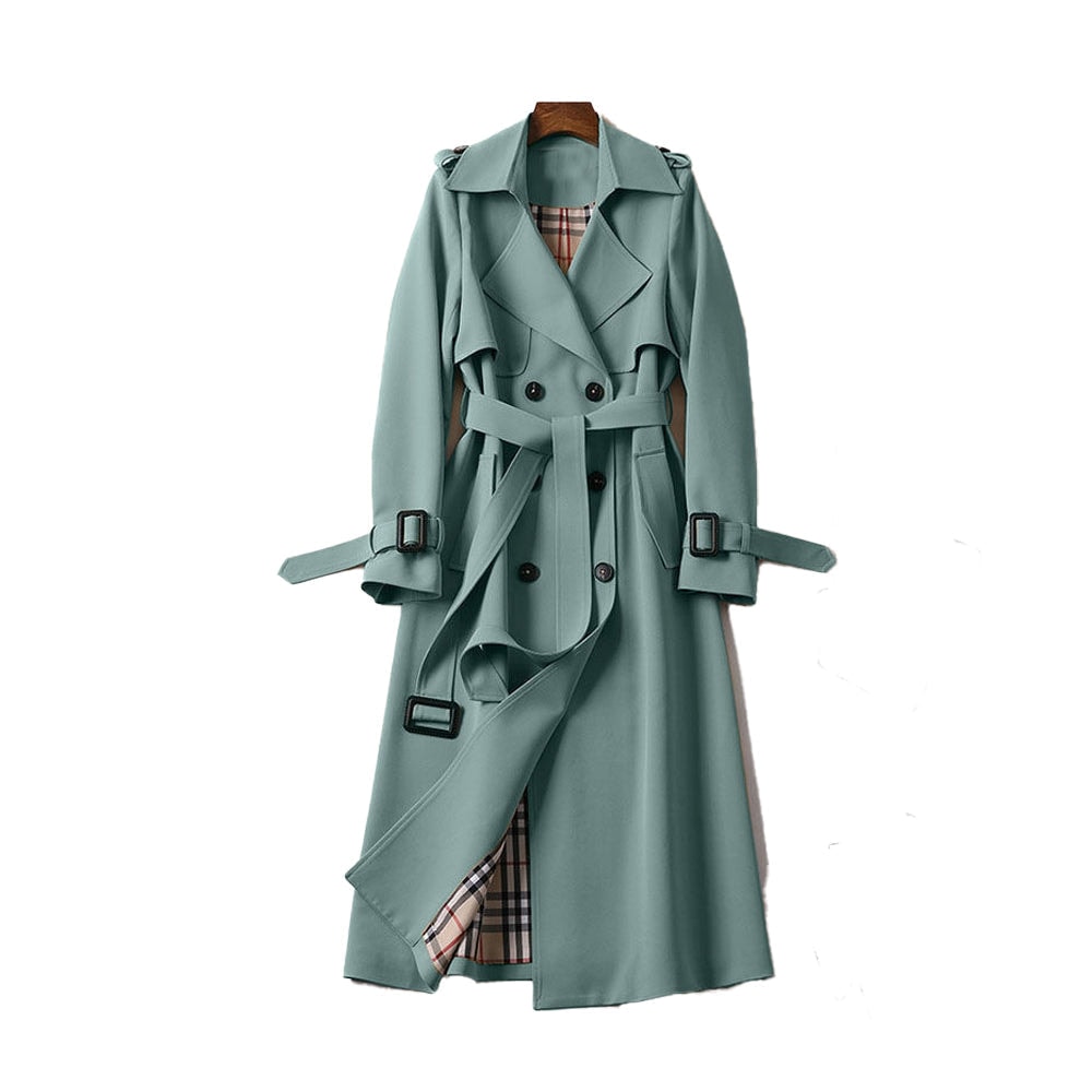 Sage green long trench coat with a classic double-breasted front, waist belt, buckled cuffs, shoulder epaulettes, storm flap, and visible plaid-patterned inner lining.