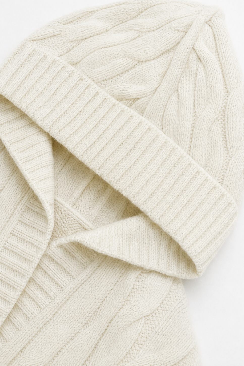 Detailed view of the cardigan hood and neckline, showing the cable knit texture and ribbed edge.