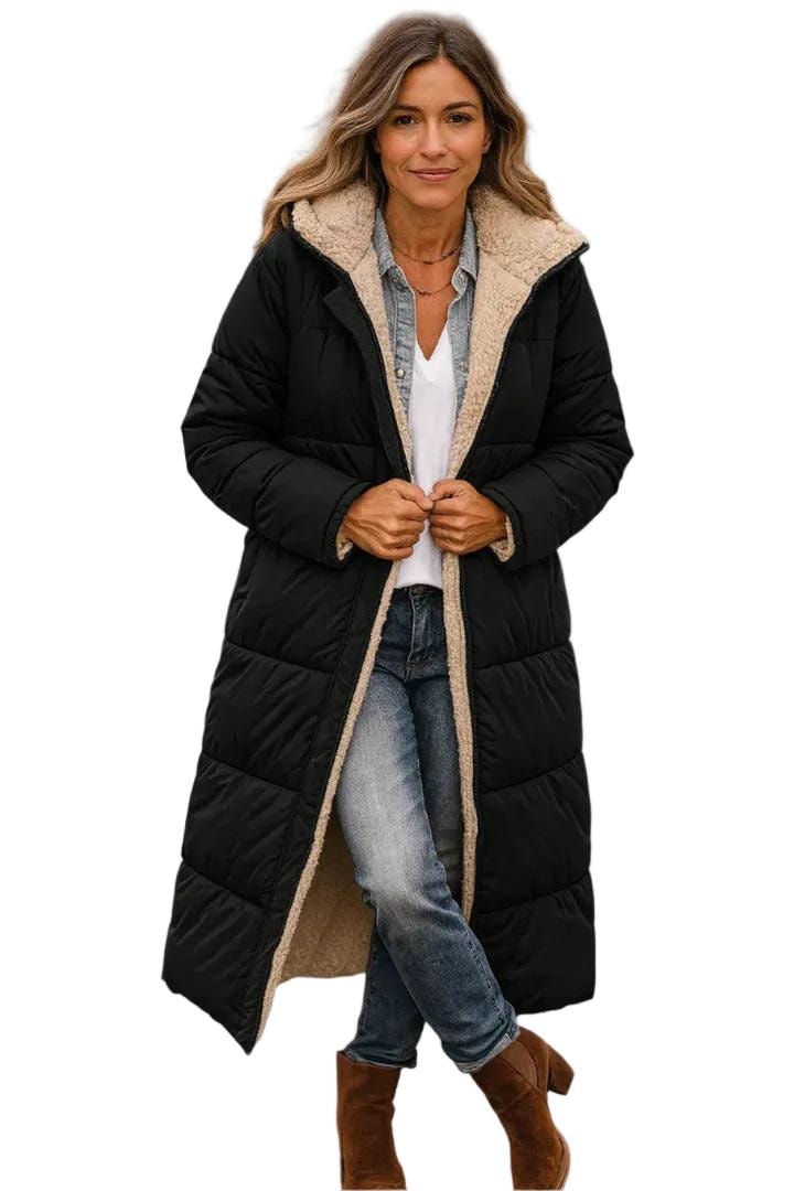 Model wearing a black long quilted coat with a plush-lined hood and open front, showing the contrasting cosy lining.