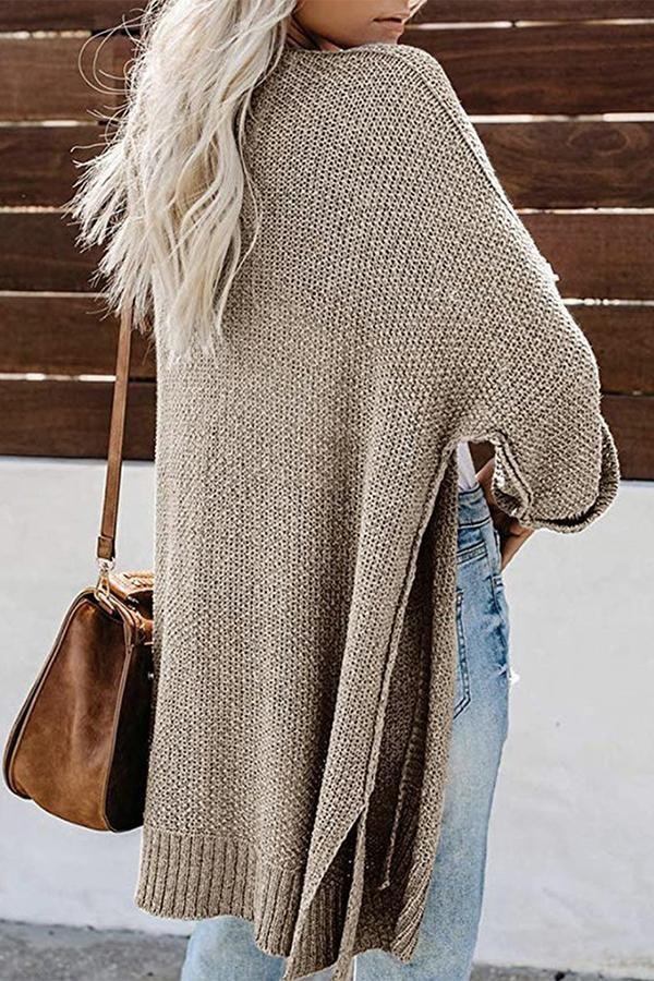 Back view of the taupe cardigan showing its long, collarless silhouette and relaxed sleeve shape.