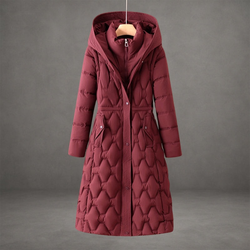 Burgundy longline hooded puffer coat with a belted waist, front zip and snap closure, and two flap pockets.