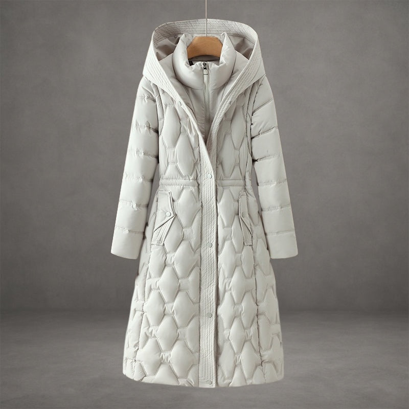 White longline hooded puffer coat showing its shaped waist, extended hem, and two front flap pockets.