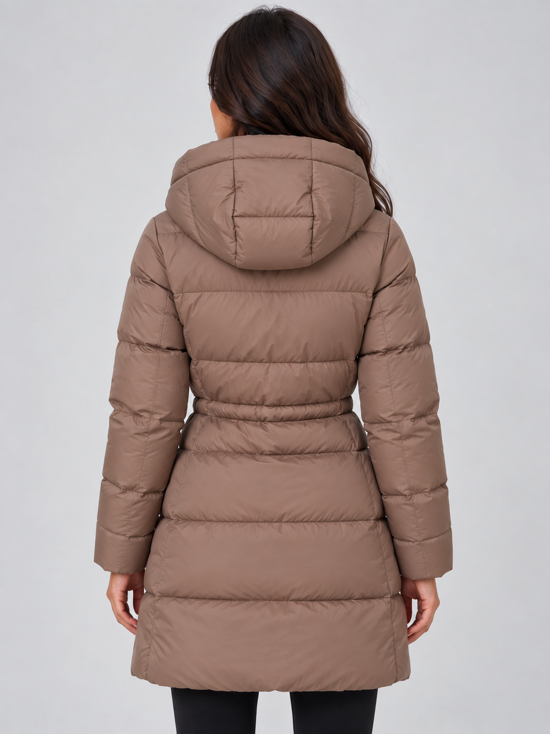 Back view of the taupe puffer coat showing its hood, quilted panels, defined waist, and above-knee length.