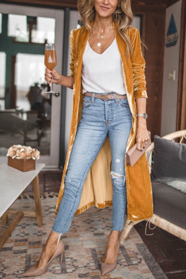Mustard longline coat shown in a wider front view, revealing its open styling and extended flowing hem.
