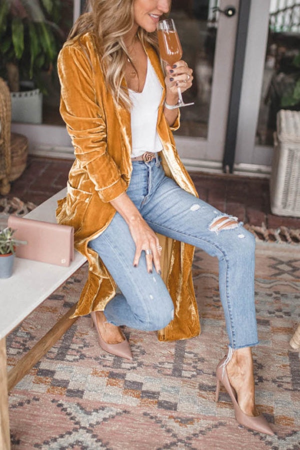 Mustard kimono coat shown from a seated side view, highlighting the long ruched sleeve and flowing hem.