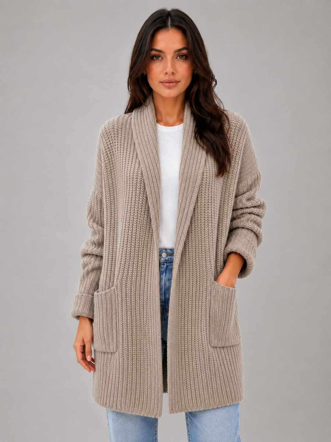 Front view of the cardigan in taupe, showing its open drape, shawl-style neckline, long sleeves, and two large patch pockets.