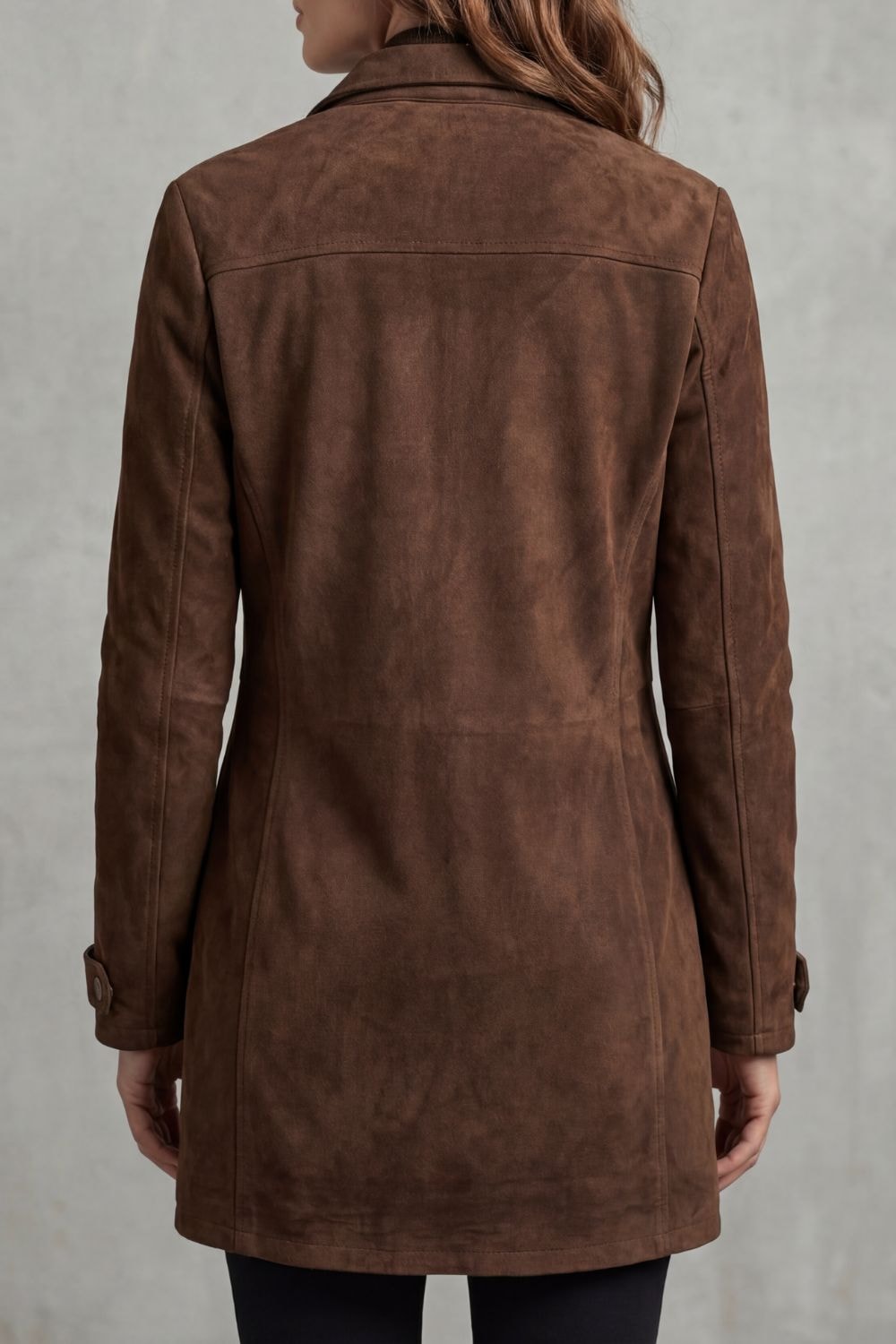 Back view of the brown longline coat showing its clean panelled design, extended hem, long sleeves, and tab cuffs.