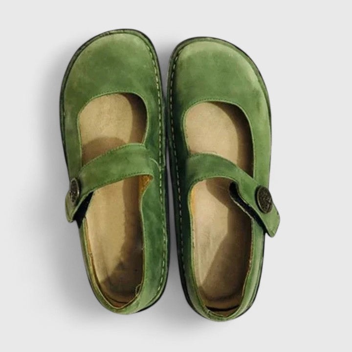 Green Mary Jane flats seen from above as a matched pair, with wide rounded toes and straps crossing the instep.