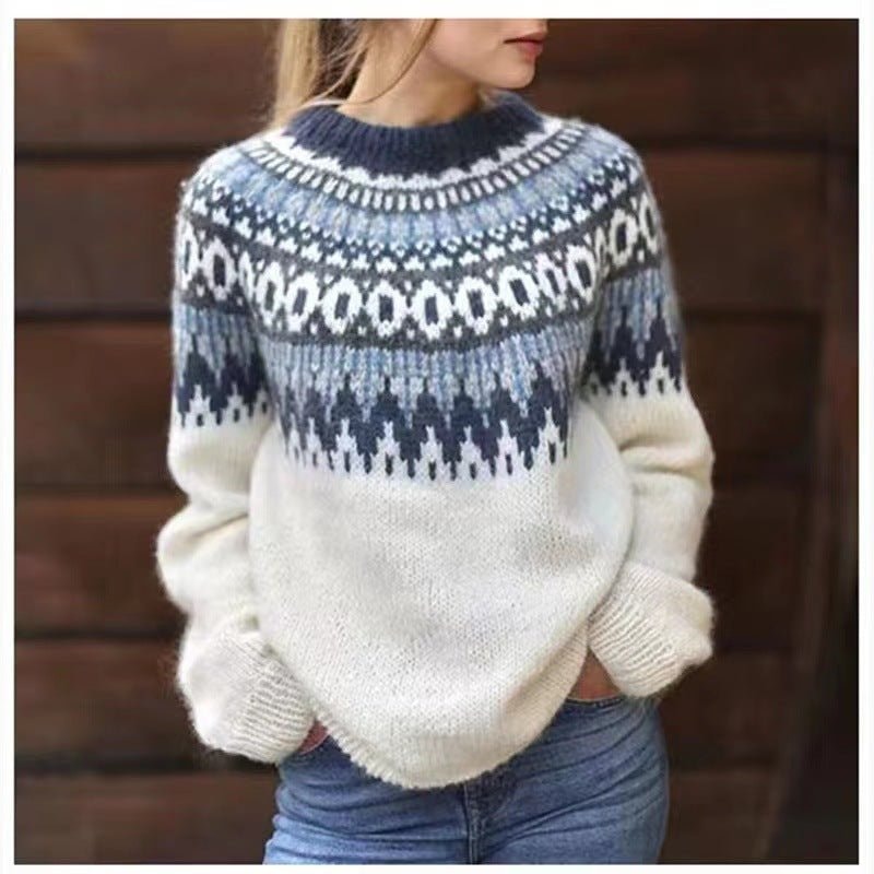 Cream crew neck sweater with a blue and white Nordic-inspired yoke pattern and long sleeves, styled with jeans.