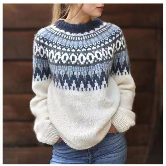 Cream crew neck sweater with a blue and white Nordic-inspired yoke pattern and long sleeves, styled with jeans.