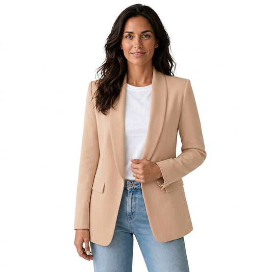 Front view of a tan open front blazer with shawl collar, long sleeves, and flap pockets, styled with a white top and jeans.
