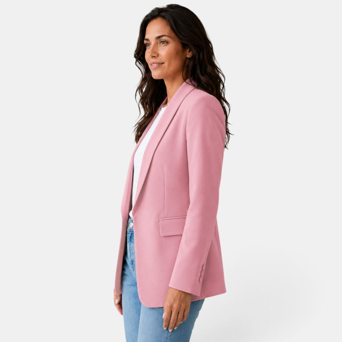 Side view of the pink blazer showing its open front, shawl collar, long sleeve, and hip flap pocket.
