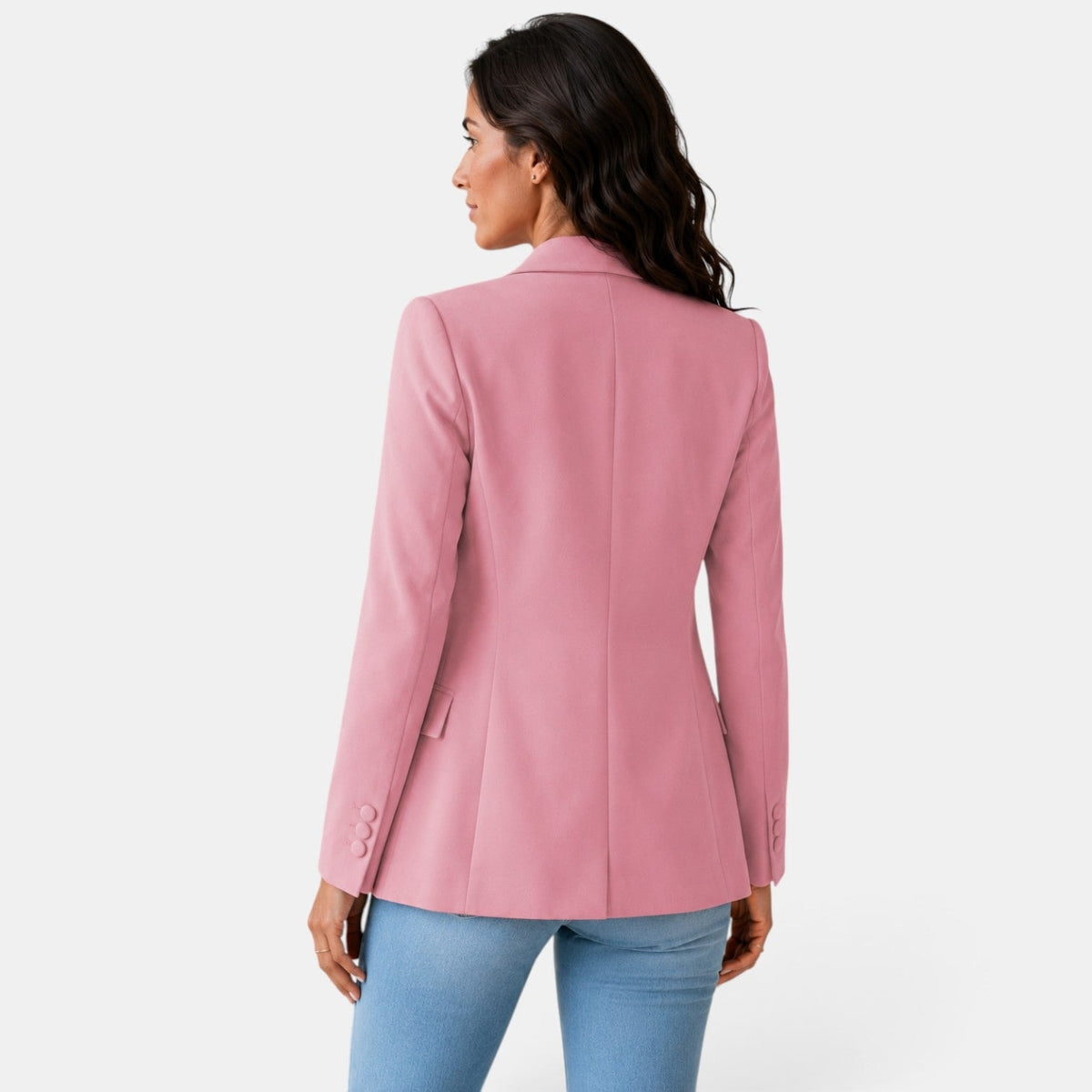 Back three-quarter view of the pink blazer displaying the center seam, shaped waist, and sleeve detailing.