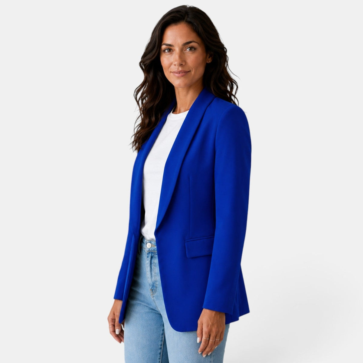 Three-quarter front view of the blue blazer showing its open front, shawl collar, long sleeves, and flap pocket.