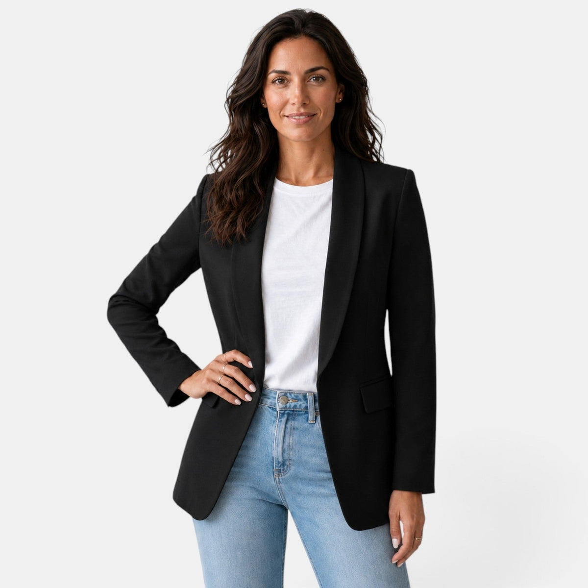Front view of a black open front blazer with structured shoulders and a shawl collar over a white top and jeans.