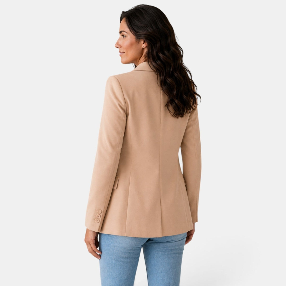 Back view of the tan blazer showing its smooth center seam, structured shoulders, and long tailored shape.