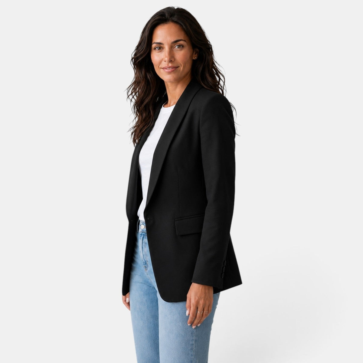 Side-front view of the black blazer displaying its open front, curved hem, shawl collar, and flap pocket.