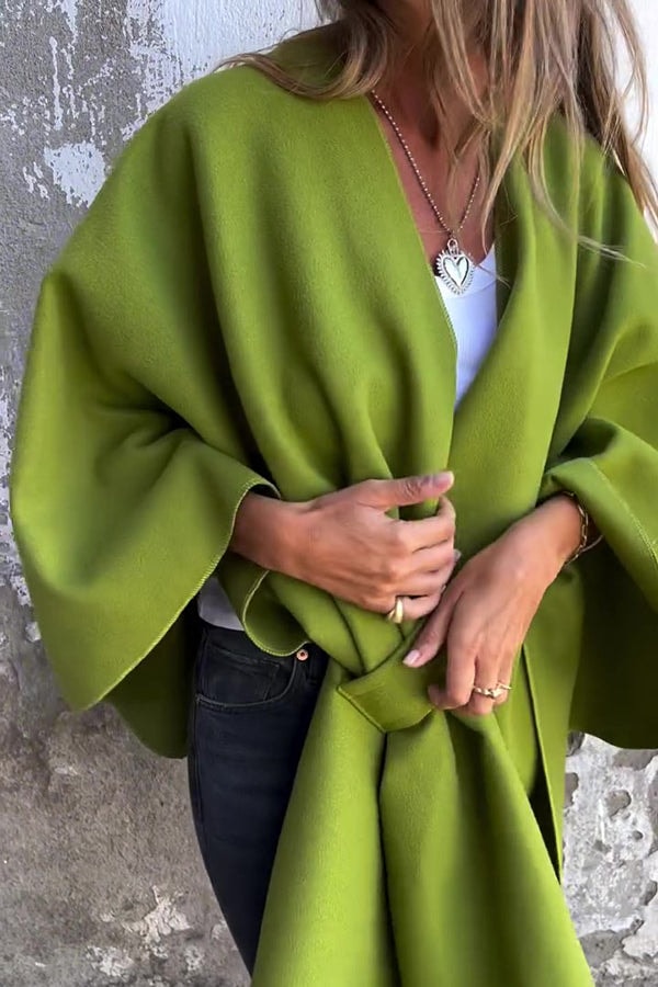 Olive green open-front cape jacket with a loose flowing silhouette, wide sleeves, and a gathered front.