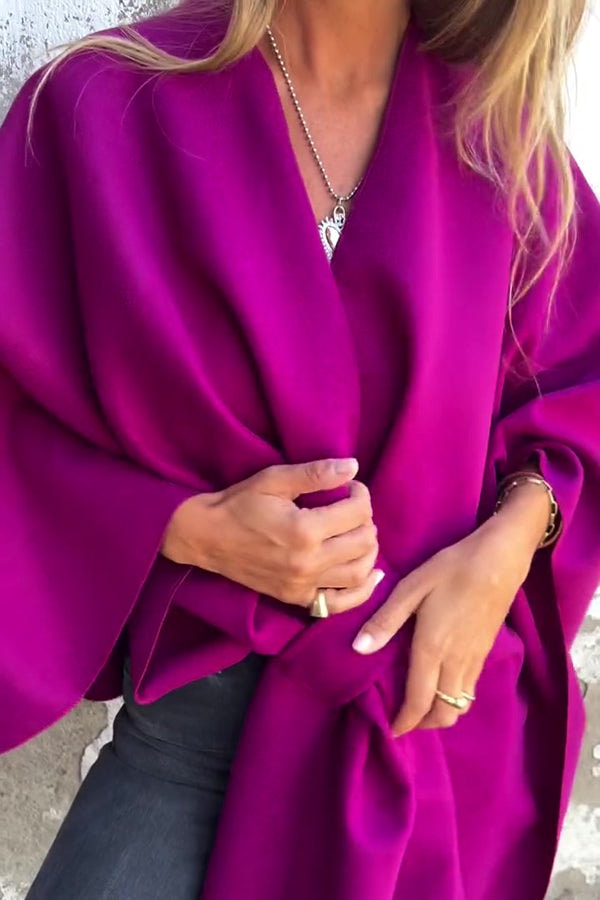 Magenta cape jacket shown with one front panel gathered at the waist, emphasizing the flowing sleeve shape.