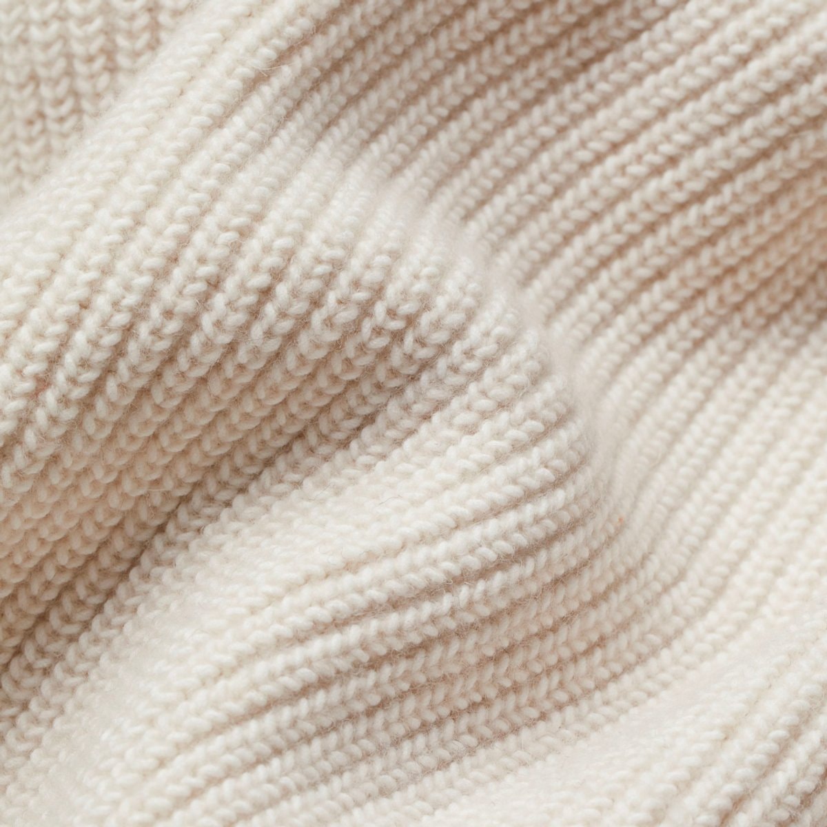 Detailed close-up of the cardigan’s raised ribbed knit texture and wide cuff finish.